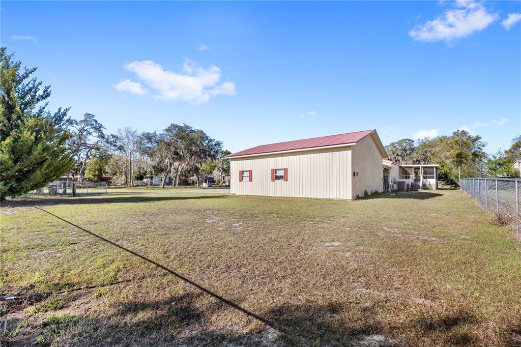 32443 Memory Lane Leesburg, FL 34788 - Photo 48 of 51 a view of a house with a yard