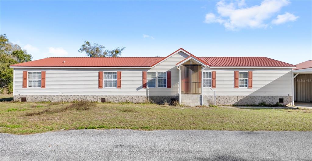 32443 Memory Lane Leesburg, FL 34788 - Photo 50 of 51 a front view of a house with a yard