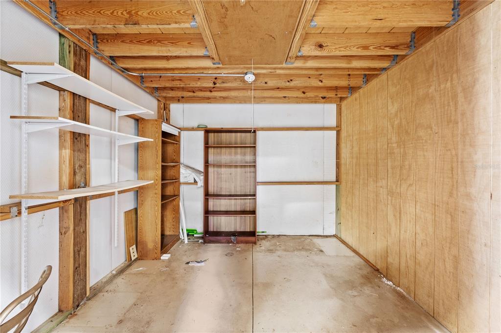 32443 Memory Lane Leesburg, FL 34788 - Photo 10 of 51 a view of a garage with wooden walls