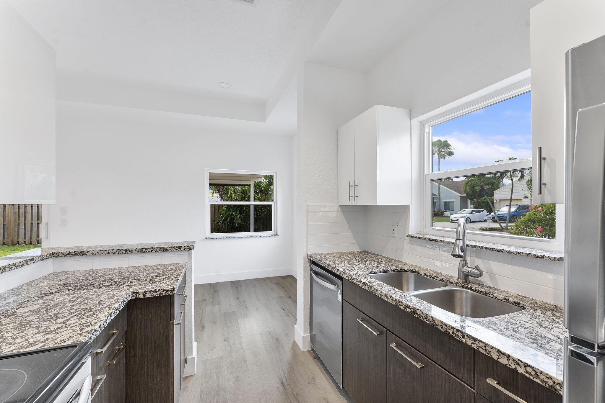 23157 Old Inlet Bridge Drive Boca Raton, FL 33433 - Photo 11 of 39 a kitchen with granite countertop a sink and a stove