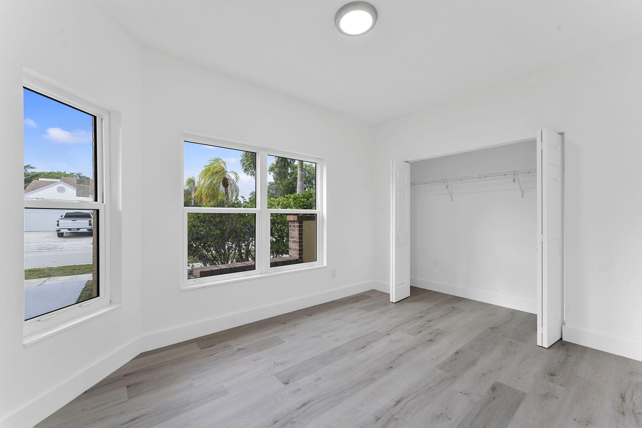 23157 Old Inlet Bridge Drive Boca Raton, FL 33433 - Photo 12 of 39 an empty room with wooden floor and windows