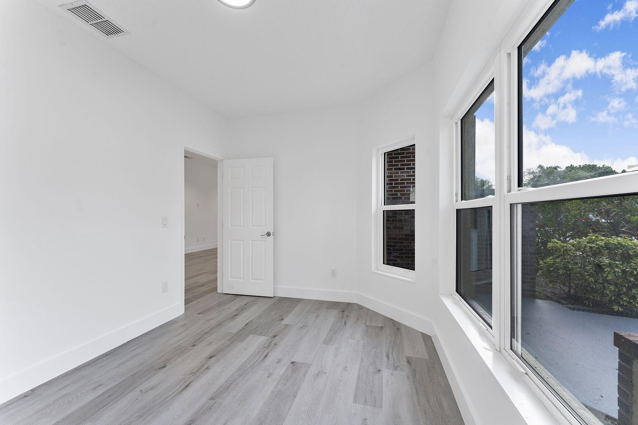 23157 Old Inlet Bridge Drive Boca Raton, FL 33433 - Photo 13 of 39 a view of a big room with wooden floor and windows
