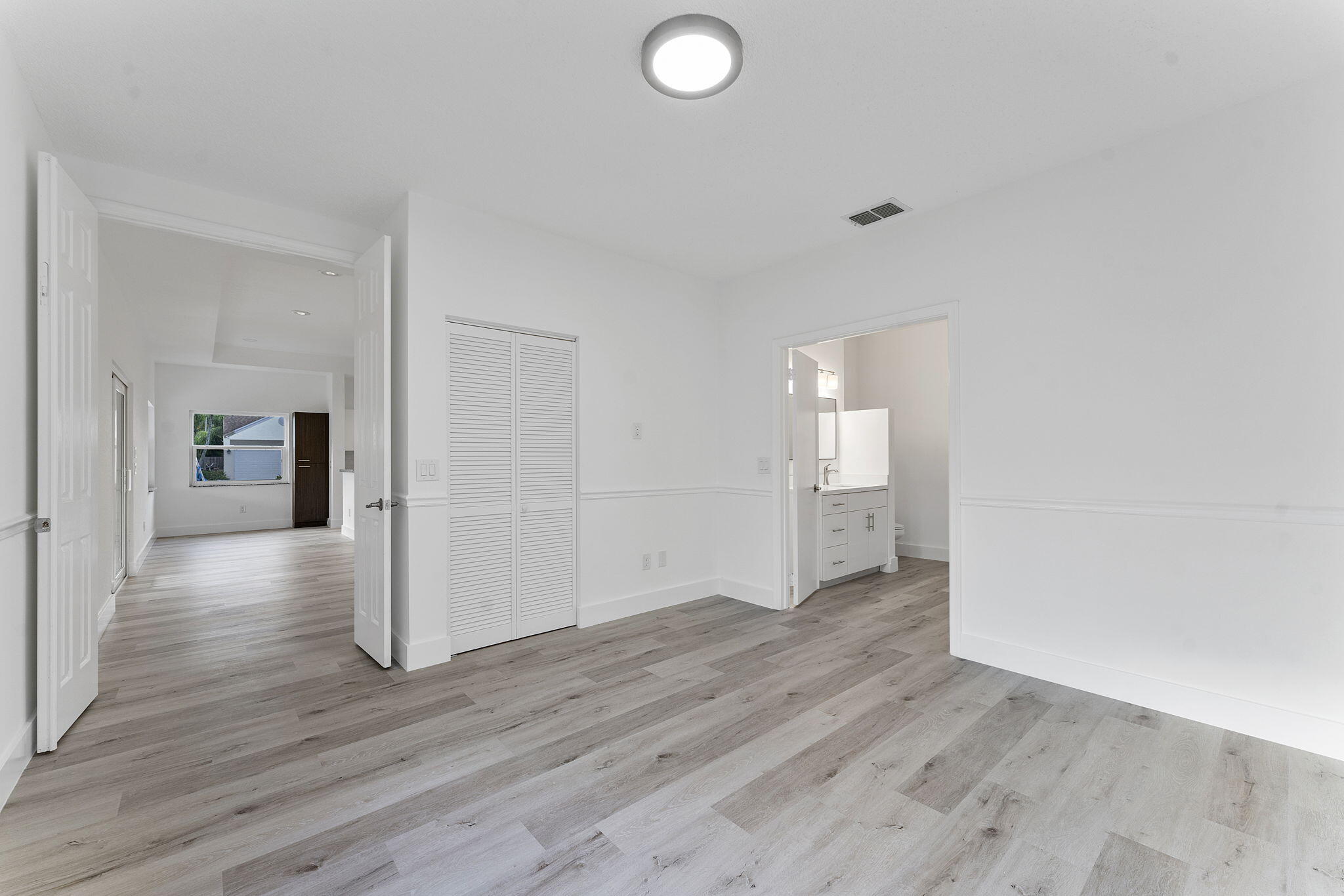 23157 Old Inlet Bridge Drive Boca Raton, FL 33433 - Photo 19 of 39 a view of an empty room with wooden floor and a window