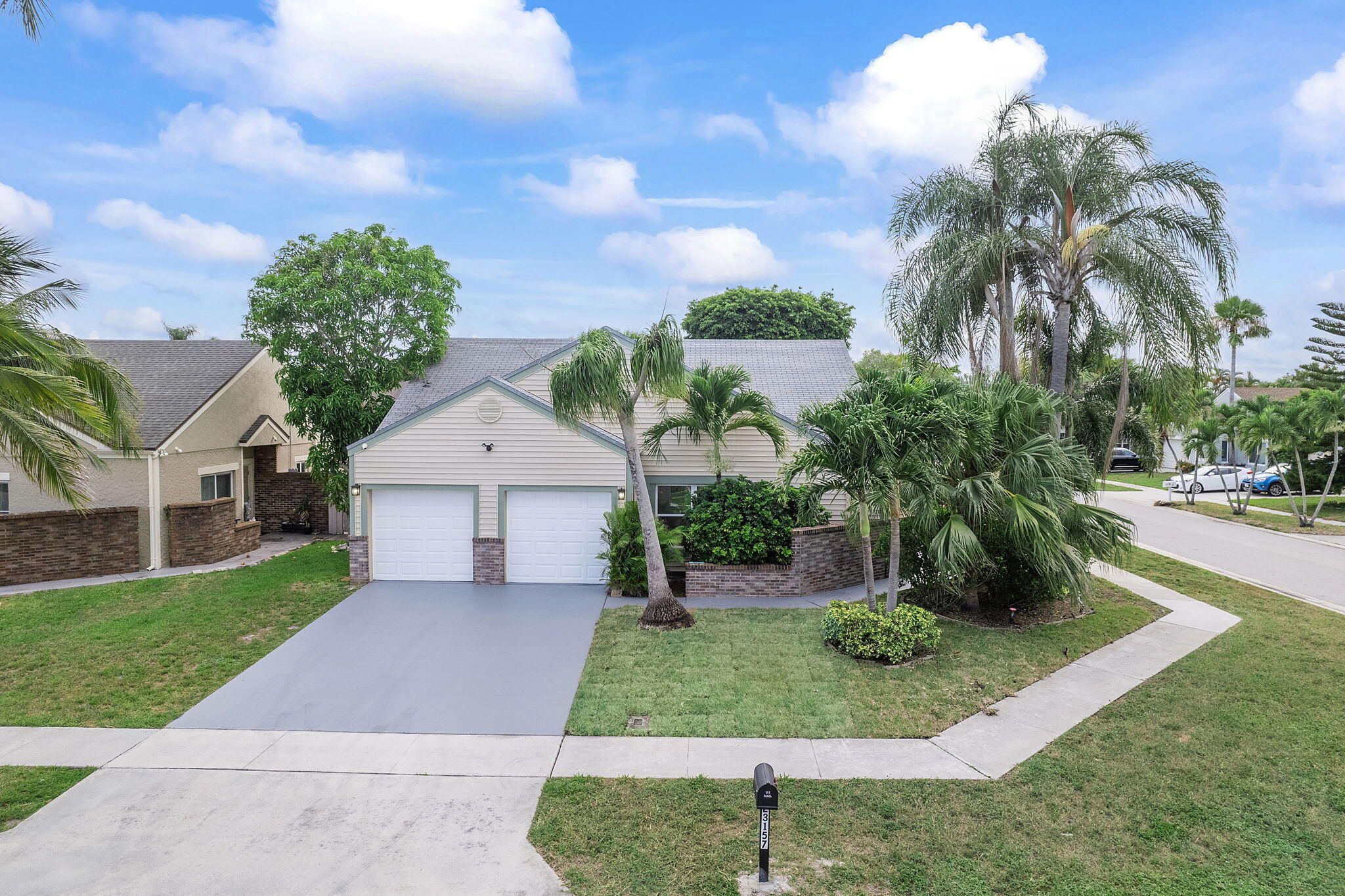 23157 Old Inlet Bridge Drive Boca Raton, FL 33433 - Photo 2 of 39 front view of house with a yard and potted plants