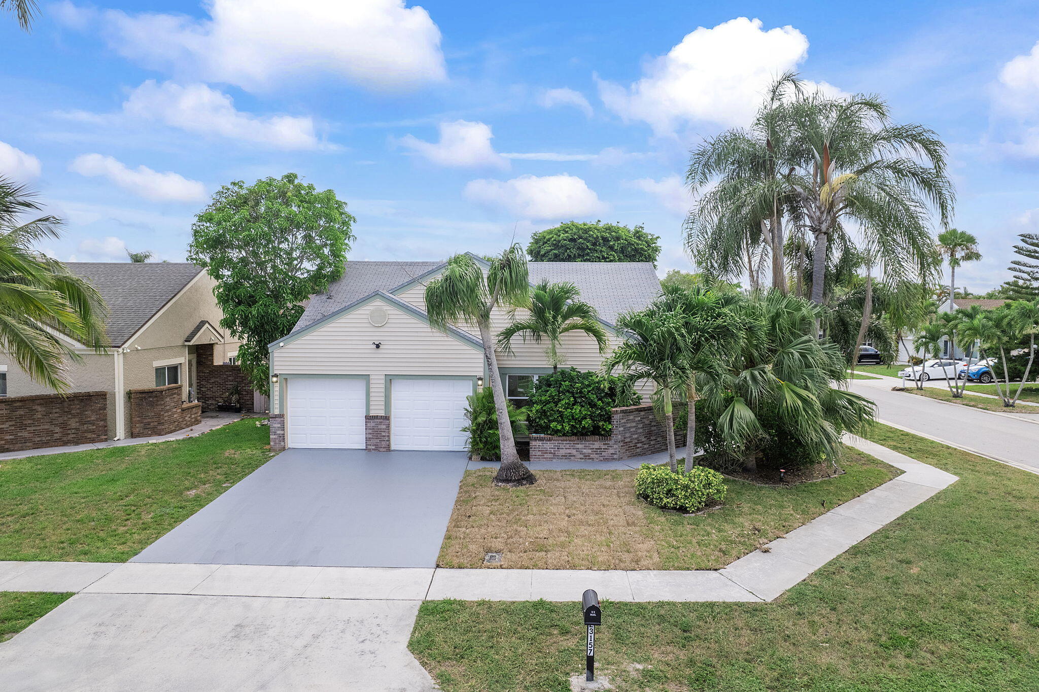 23157 Old Inlet Bridge Drive Boca Raton, FL 33433 - Photo 23 of 39 a front view of a house with garden