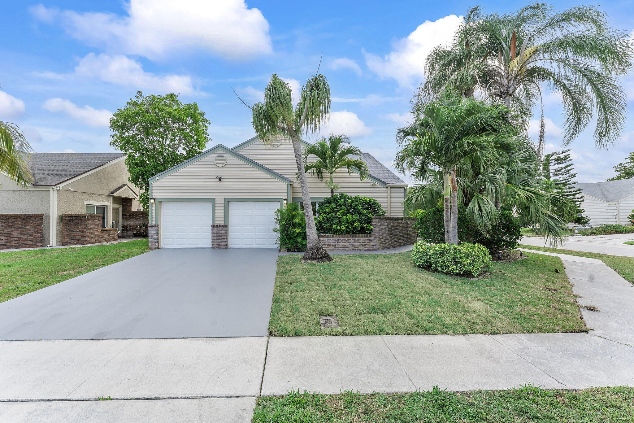 23157 Old Inlet Bridge Drive Boca Raton, FL 33433 - Photo 37 of 39 a front view of a house with garden
