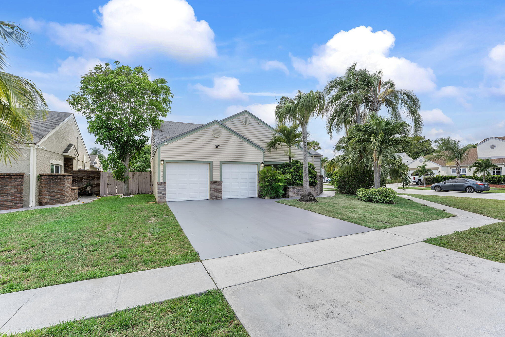 23157 Old Inlet Bridge Drive Boca Raton, FL 33433 - Photo 38 of 39 a front view of a house with a yard and garage
