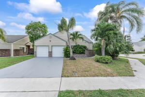23157 Old Inlet Bridge Drive Boca Raton, FL 33433 - Photo 39 of 39 a front view of a house with garden