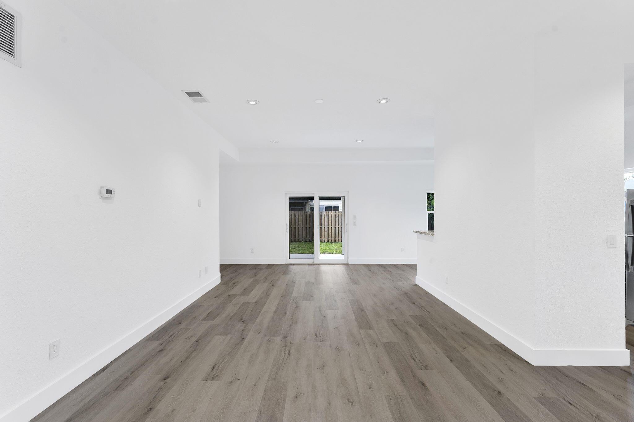 23157 Old Inlet Bridge Drive Boca Raton, FL 33433 - Photo 4 of 39 an empty room with wooden floor and windows
