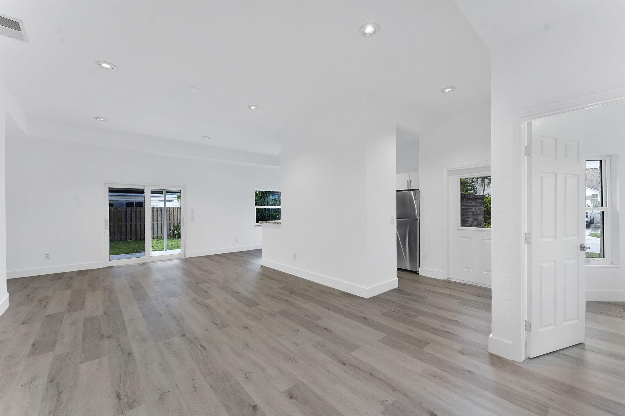 23157 Old Inlet Bridge Drive Boca Raton, FL 33433 - Photo 5 of 39 an empty room with wooden floor and windows
