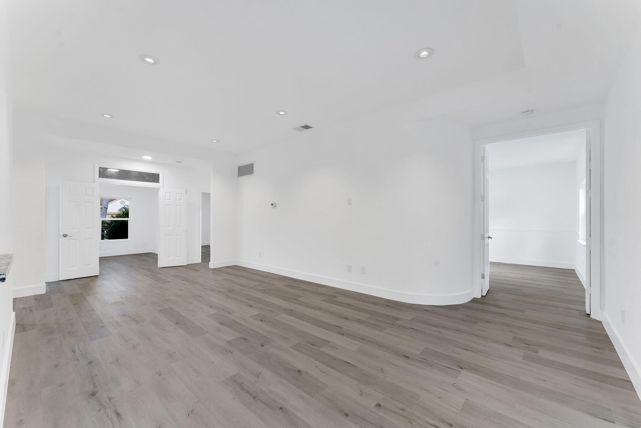 23157 Old Inlet Bridge Drive Boca Raton, FL 33433 - Photo 8 of 39 a view of an empty room with wooden floor