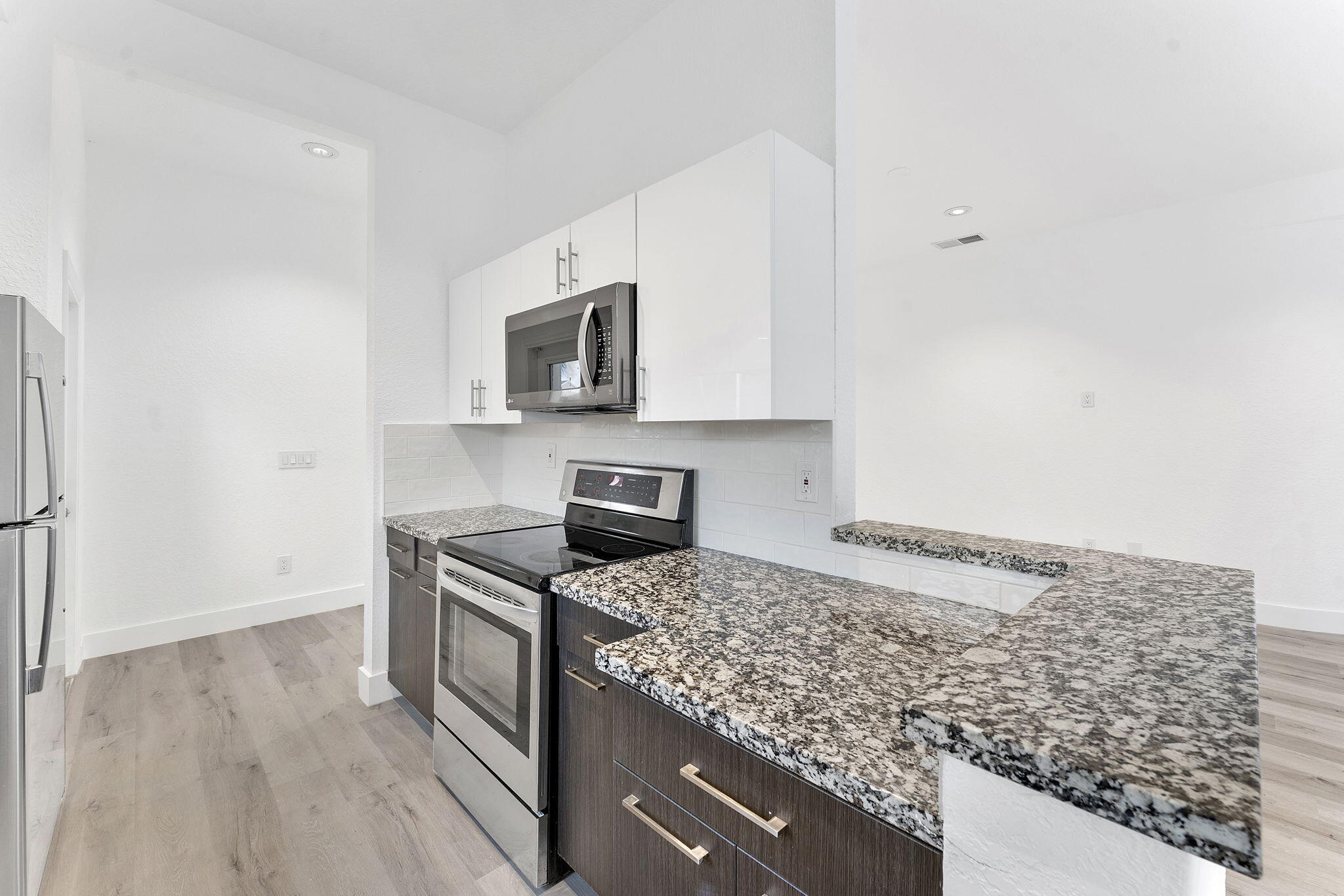 23157 Old Inlet Bridge Drive Boca Raton, FL 33433 - Photo 10 of 39 a kitchen with stainless steel appliances granite countertop a sink stove and microwave