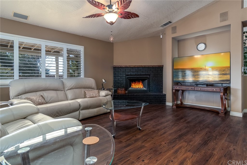 12990 Choco Road Apple Valley, CA 92308 - Photo 1 of 1 a living room with furniture and a fireplace