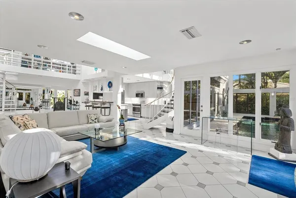 a living room with furniture a rug and a ceiling fan