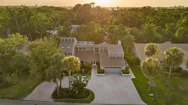 an aerial view of a house with a yard and a fountain