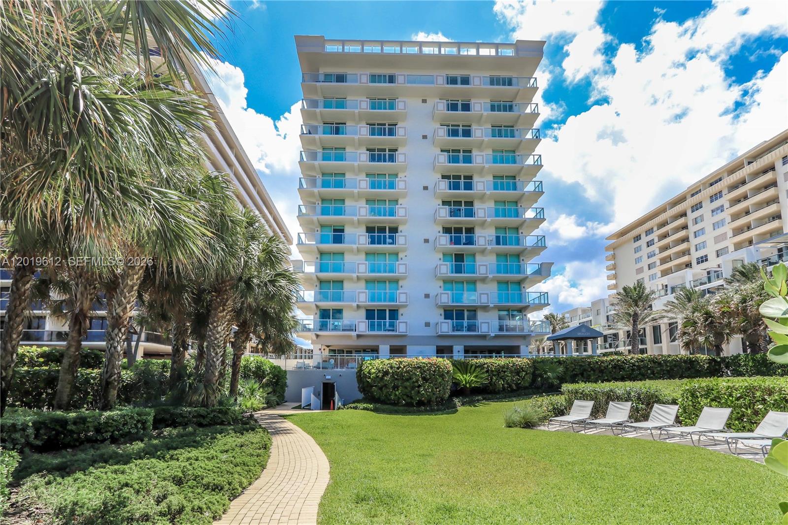 9499 Collins Avenue, Unit 705 Surfside, FL 33154 - Photo 19 of 29 a view of a tall building with a yard
