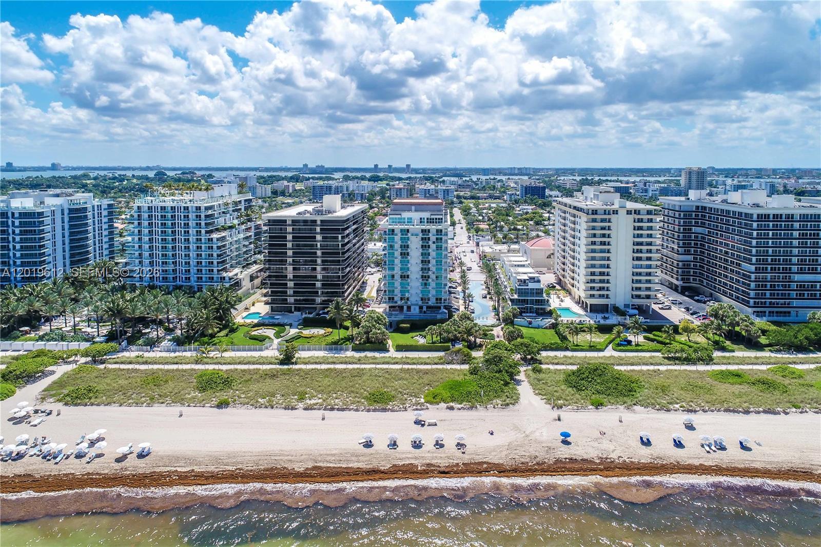 9499 Collins Avenue, Unit 705 Surfside, FL 33154 - Photo 24 of 29 a view of a city with tall buildings and a yard