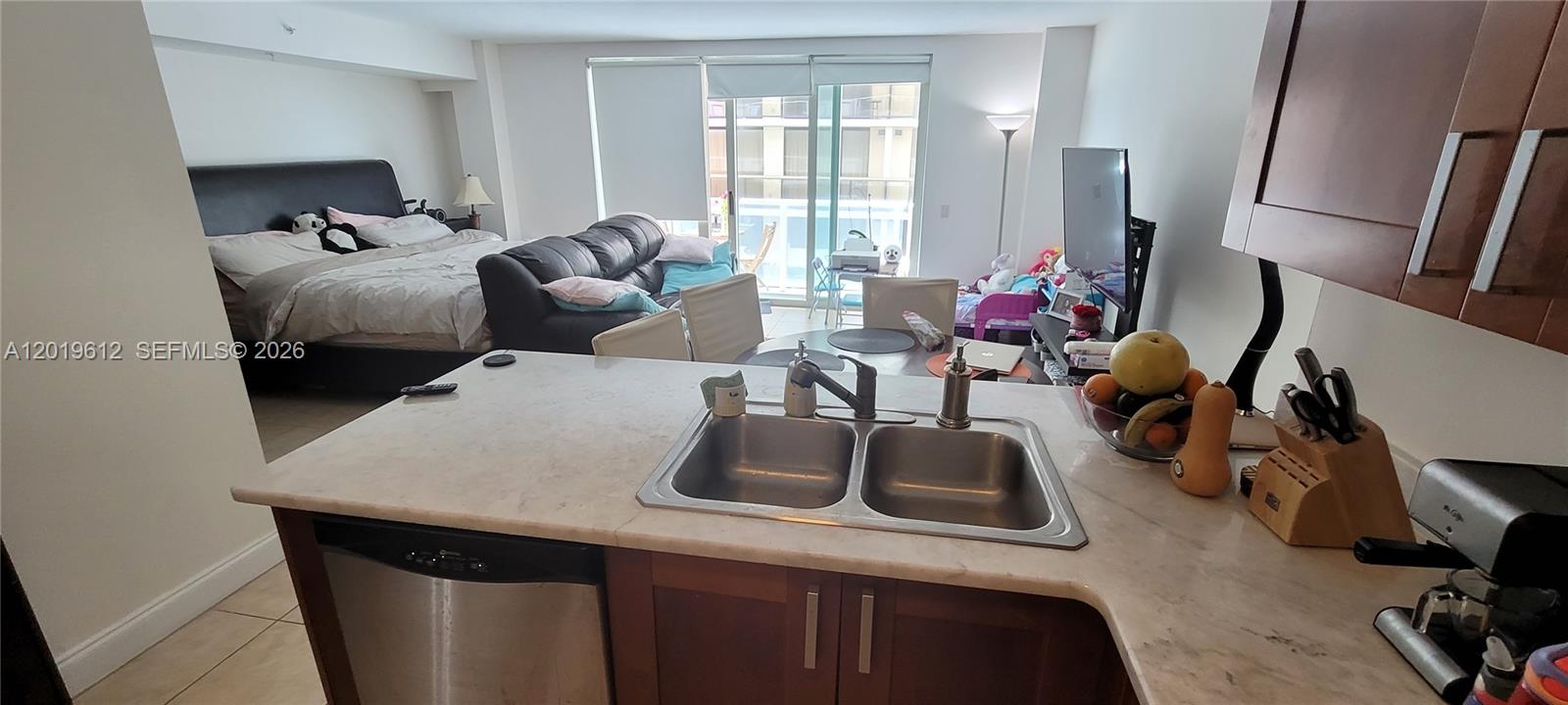 9499 Collins Avenue, Unit 705 Surfside, FL 33154 - Photo 6 of 29 a bedroom with furniture and a window