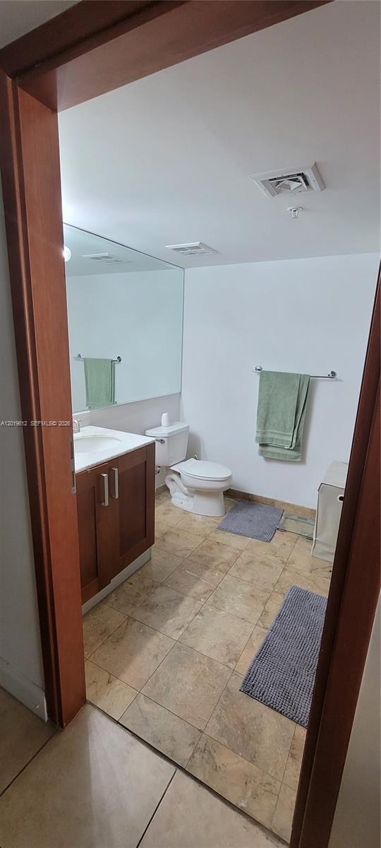 9499 Collins Avenue, Unit 705 Surfside, FL 33154 - Photo 9 of 29 a bathroom with a sink a toilet and shower