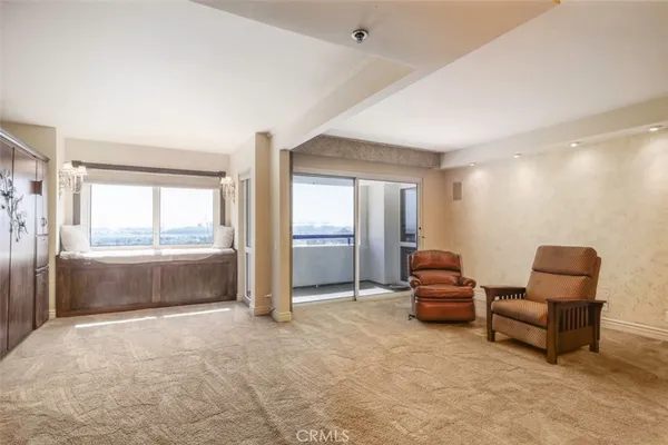 a living room with furniture and a floor to ceiling window