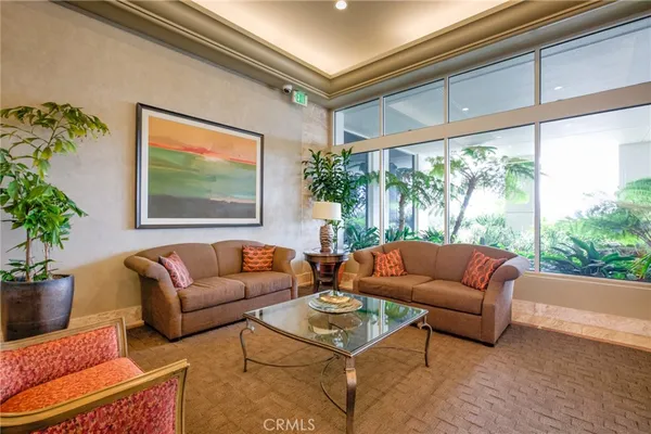 a living room with furniture and a potted plant