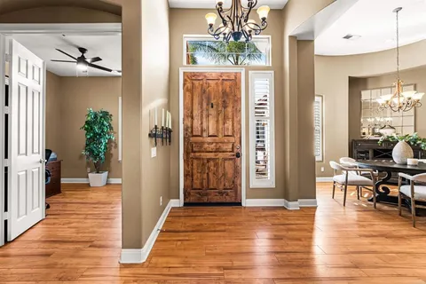 a living room with furniture a fireplace and a large window