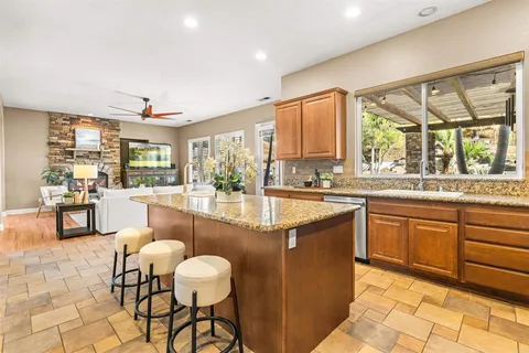 a kitchen with stainless steel appliances granite countertop a refrigerator and a sink