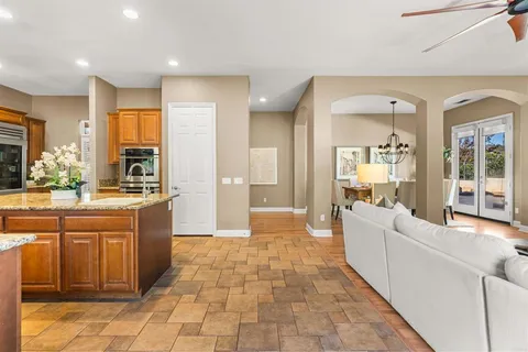a view of a dining room with furniture wooden floor and chandelier