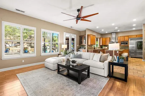 a hallway with couches and a dining table next to a window