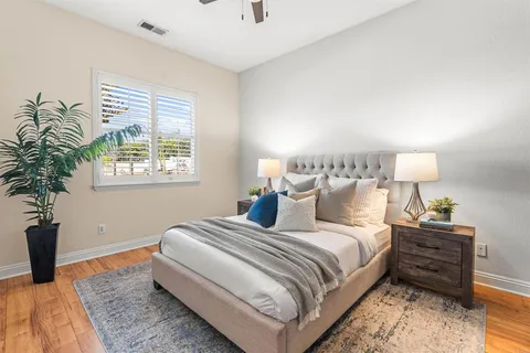 a spacious bathroom with a tub double sink window and mirror