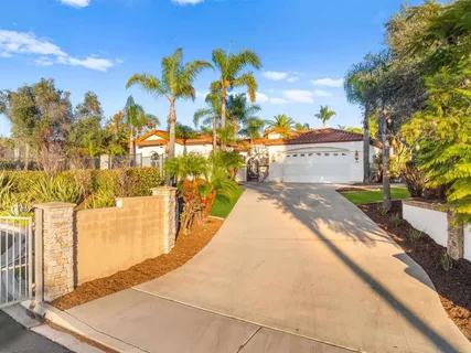 a view of a patio with dining table and chairs potted plants