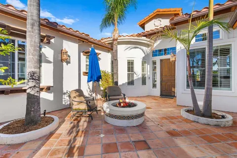 a view of a hallway with wooden floor and furniture