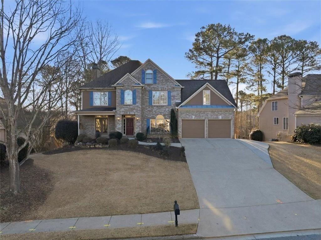 a front view of a house with a yard covered in snow
