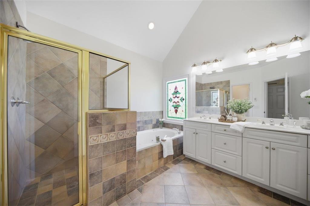 834 Valley Drive Canton, GA 30114 - Photo 21 of 49 a bathroom with a double vanity sink mirror and shower