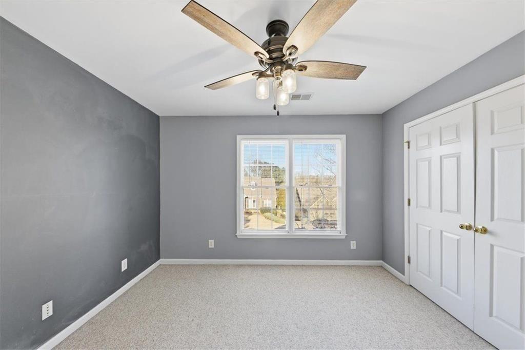 834 Valley Drive Canton, GA 30114 - Photo 26 of 49 an empty room with windows and fan