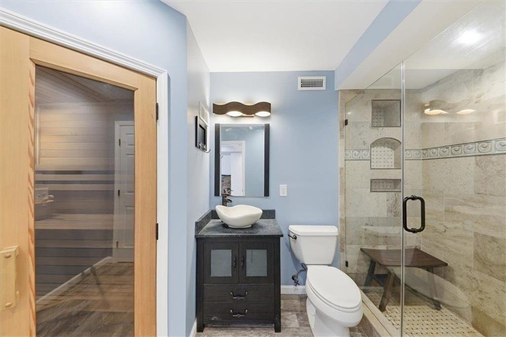 834 Valley Drive Canton, GA 30114 - Photo 33 of 49 a bathroom with a toilet a sink and mirror