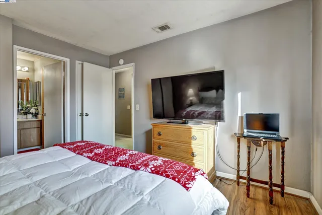 a bedroom with a bed and a flat screen tv