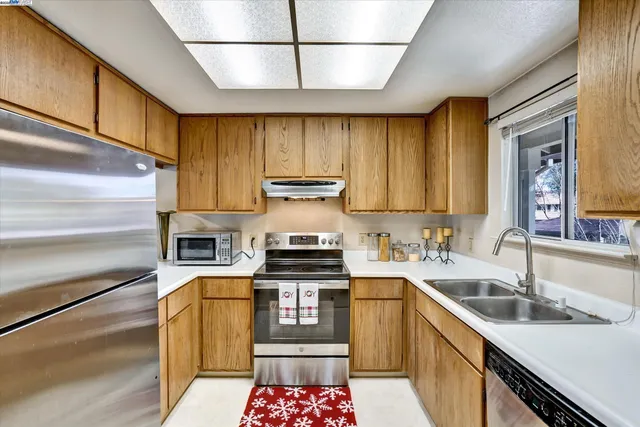 a kitchen with a sink a stove and cabinets