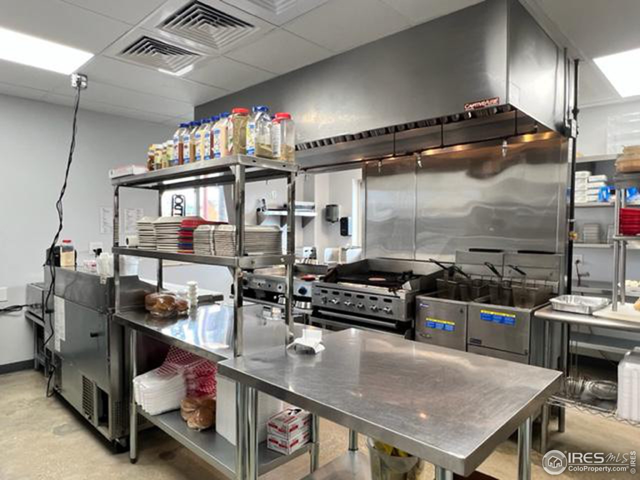 688 Main Street Walden, CO 80480 - Photo 14 of 22 a kitchen with stainless steel appliances granite countertop a stove a sink and a microwave