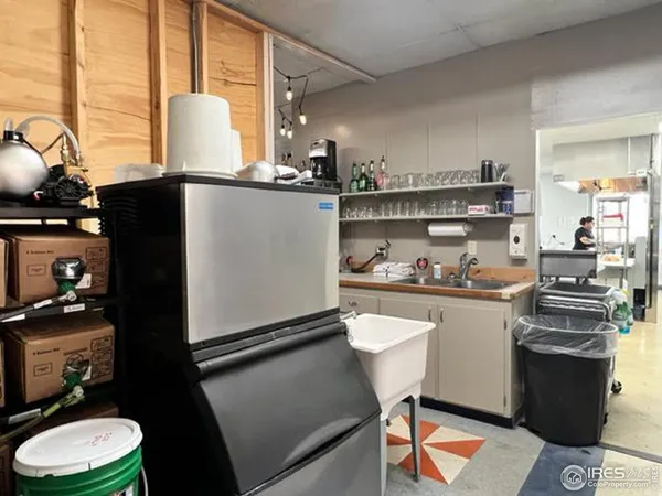 a kitchen with a sink appliances and cabinets