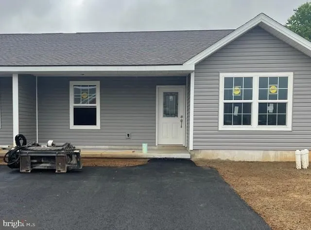 a view of a house with a barbeque and wooden fence