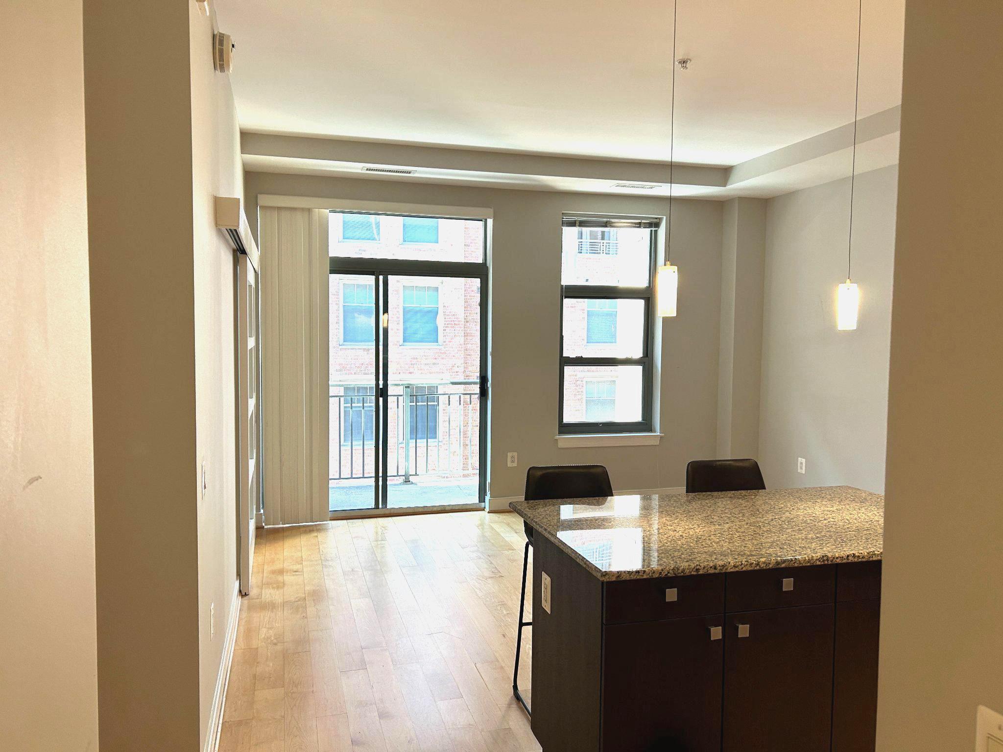 2425 L Street Northwest, Unit 421 Washington, DC 20037 - Photo 2 of 18 Open plan kitchen and living room with balcony