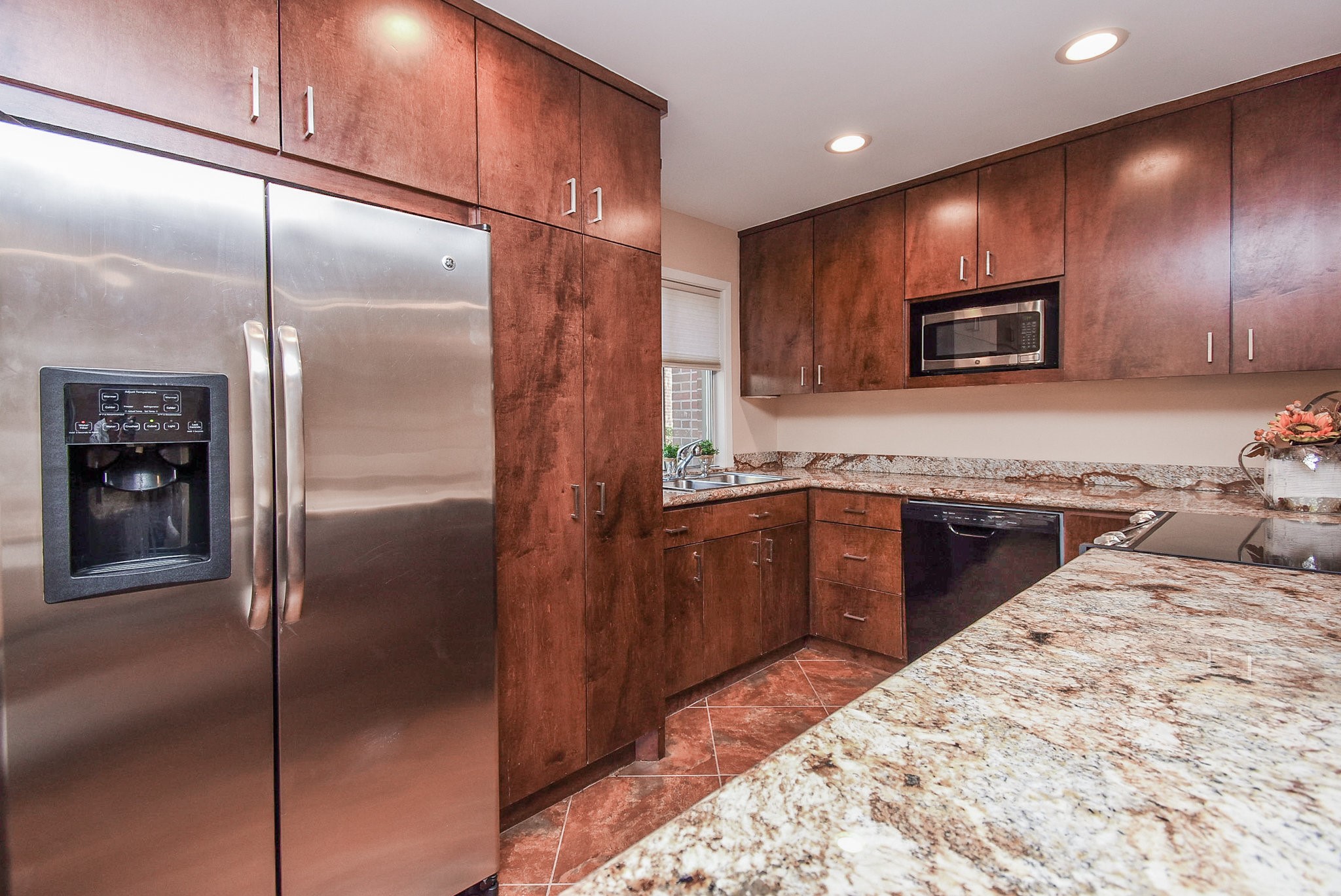 6401 Bayou Glen Road Houston, TX 77057 - Photo 11 of 22 a kitchen with stainless steel appliances granite countertop a refrigerator a stove and a sink with wooden floor