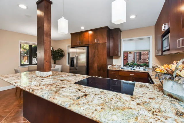 a kitchen with granite countertop sink and cabinets