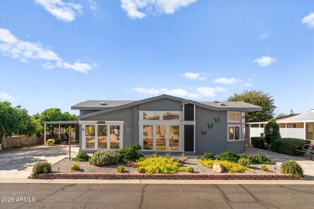 a front view of a house with a yard and outdoor seating