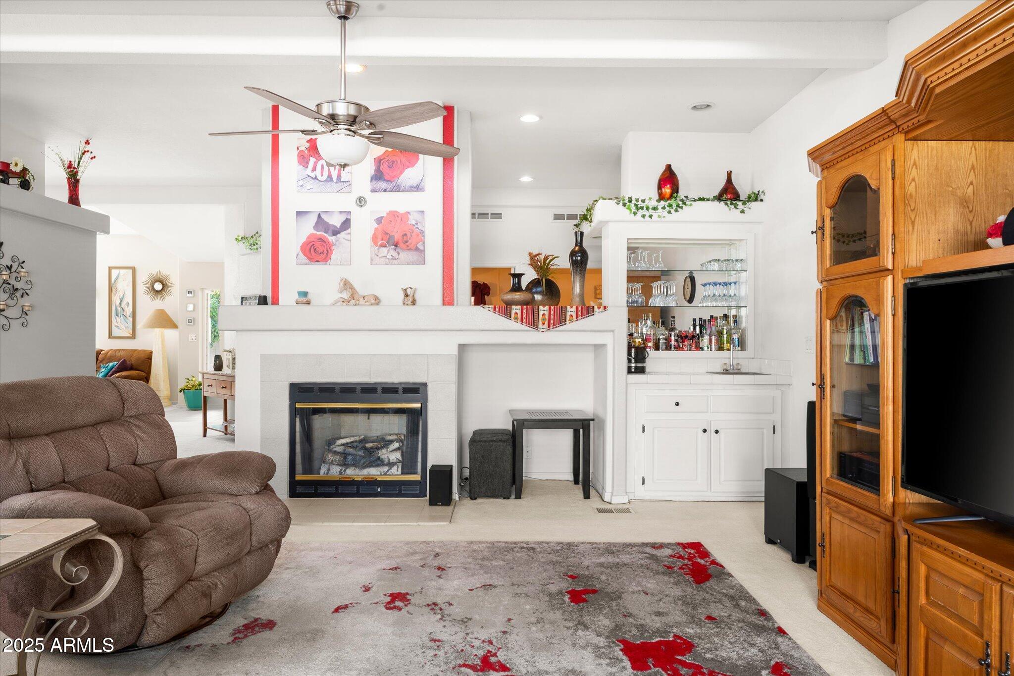 3700 South Tomahawk Road, Unit 26 & 27 Apache Junction, AZ 85119 - Photo 14 of 62 a living room with furniture a flat screen tv and a fireplace