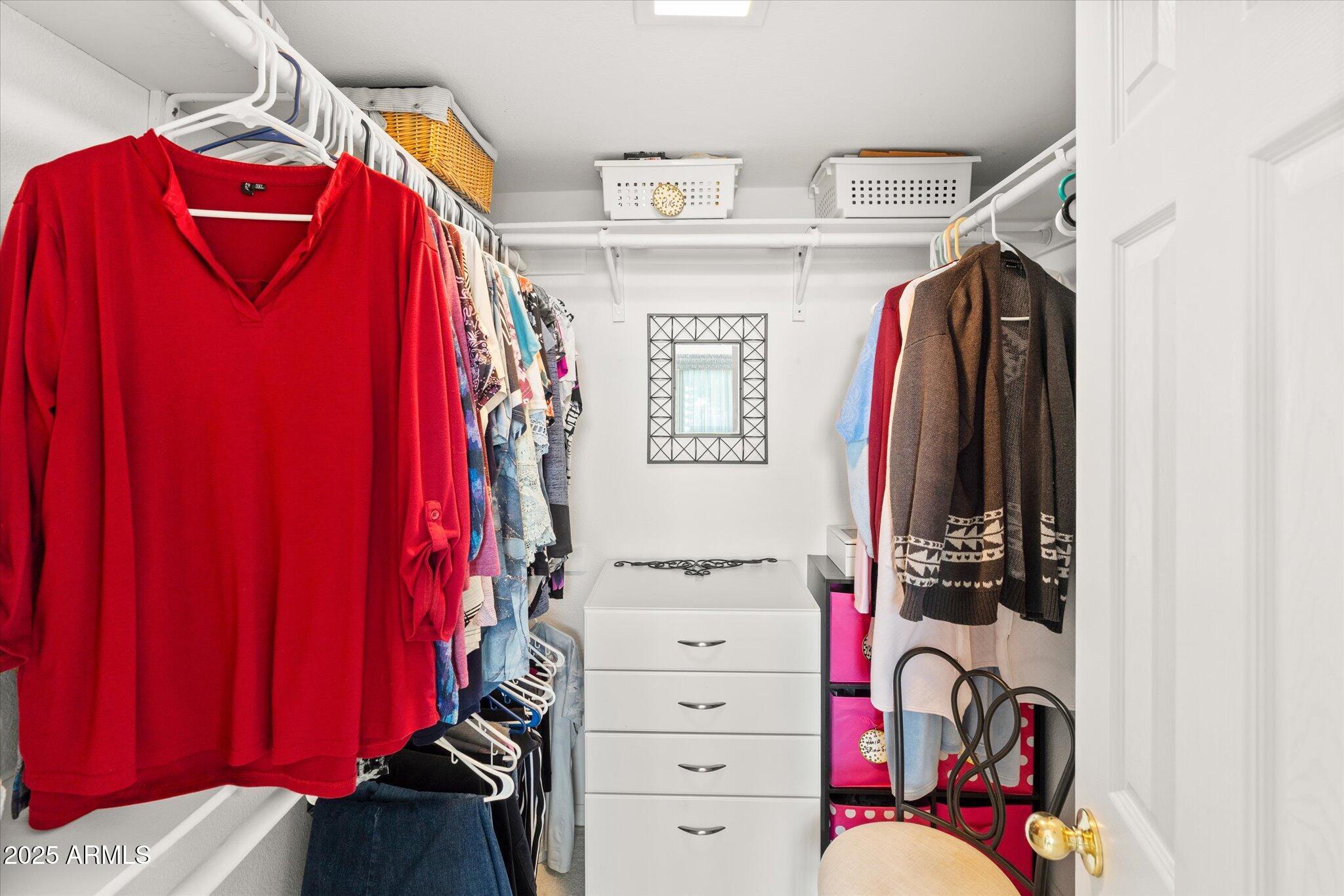3700 South Tomahawk Road, Unit 26 & 27 Apache Junction, AZ 85119 - Photo 31 of 62 a view of walk in closet with clothes and shoes