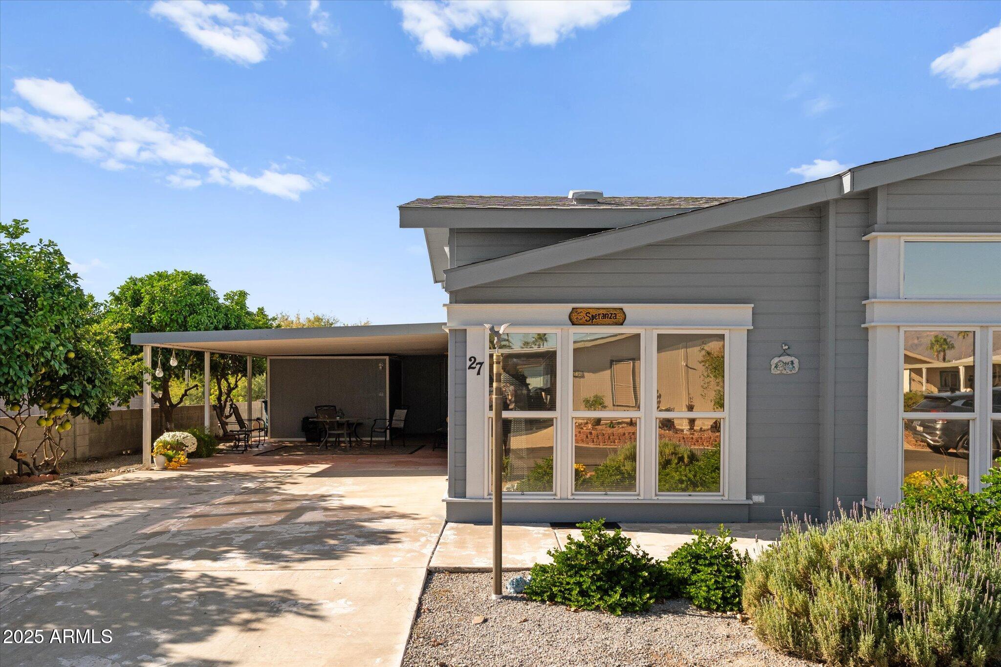 3700 South Tomahawk Road, Unit 26 & 27 Apache Junction, AZ 85119 - Photo 48 of 62 a front view of a house with a yard