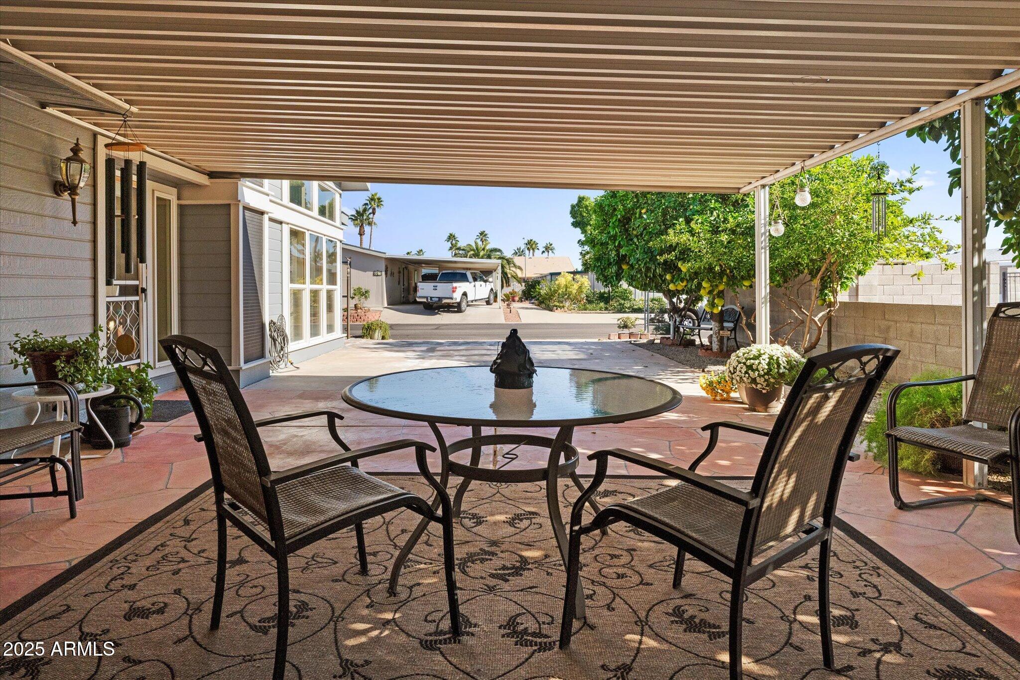 3700 South Tomahawk Road, Unit 26 & 27 Apache Junction, AZ 85119 - Photo 5 of 62 a patio with table and chairs and potted plants
