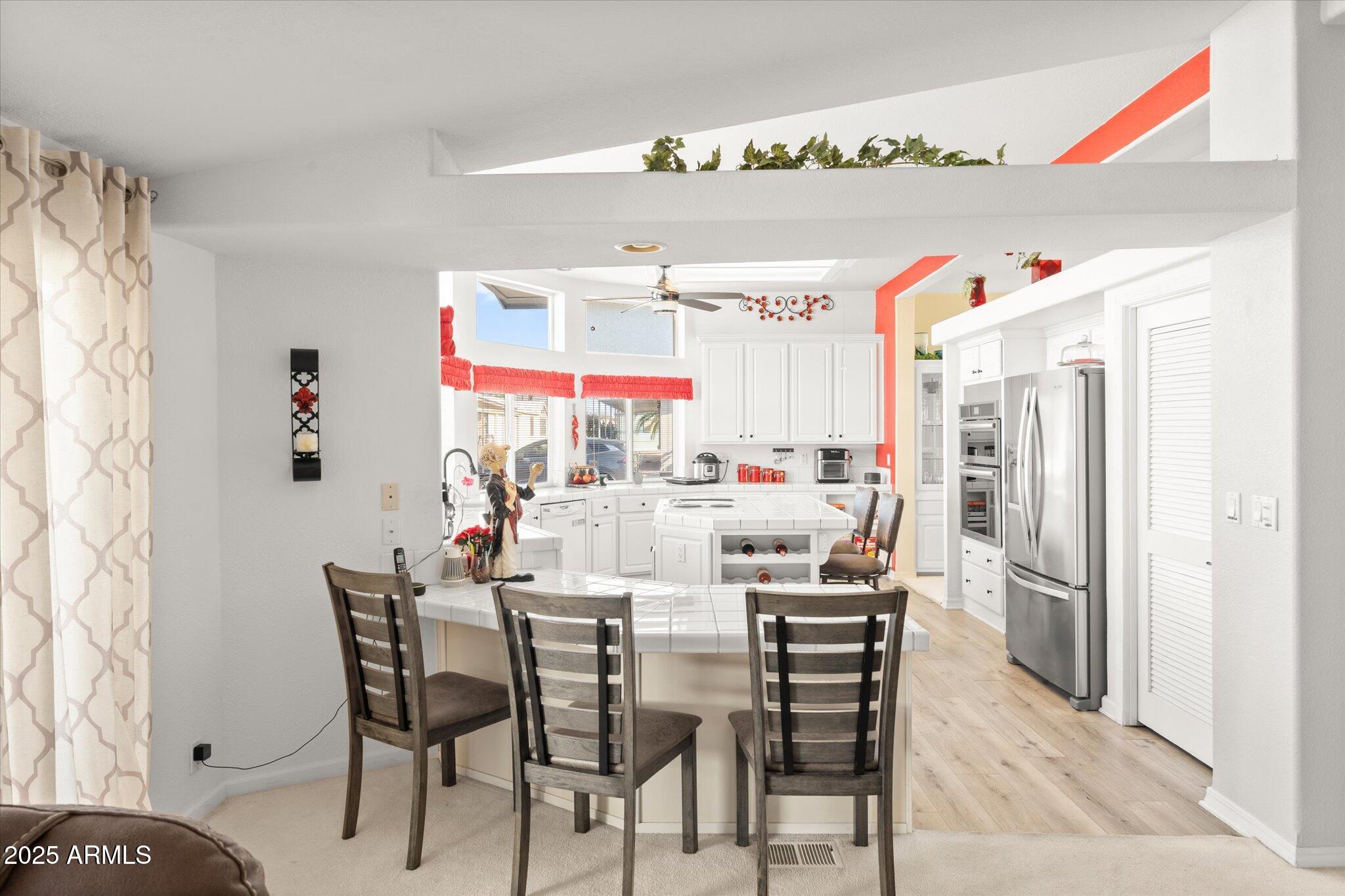 3700 South Tomahawk Road, Unit 26 & 27 Apache Junction, AZ 85119 - Photo 10 of 62 a kitchen with stainless steel appliances kitchen island granite countertop a refrigerator and microwave